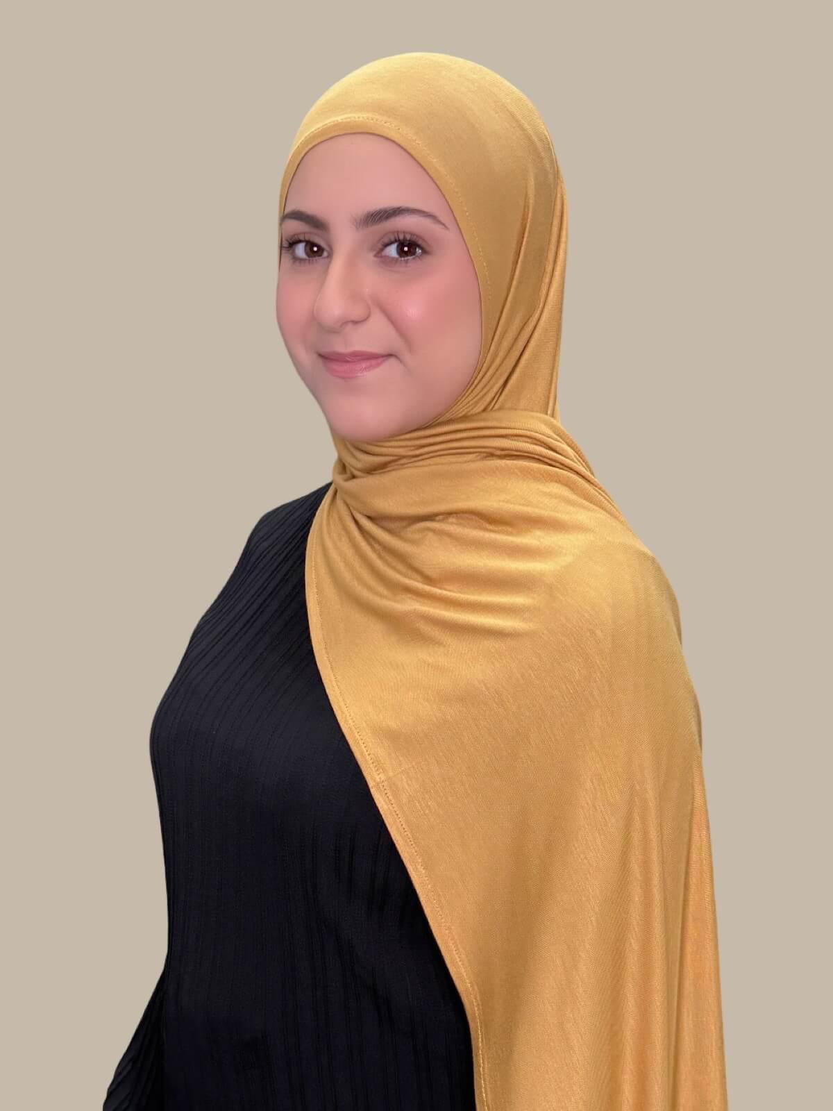 Saffron Pre-Sewn Jersey Hijab in Modish Girl size, side view on model with hijab draped over shoulder showing smooth fit and soft stretch fabric.