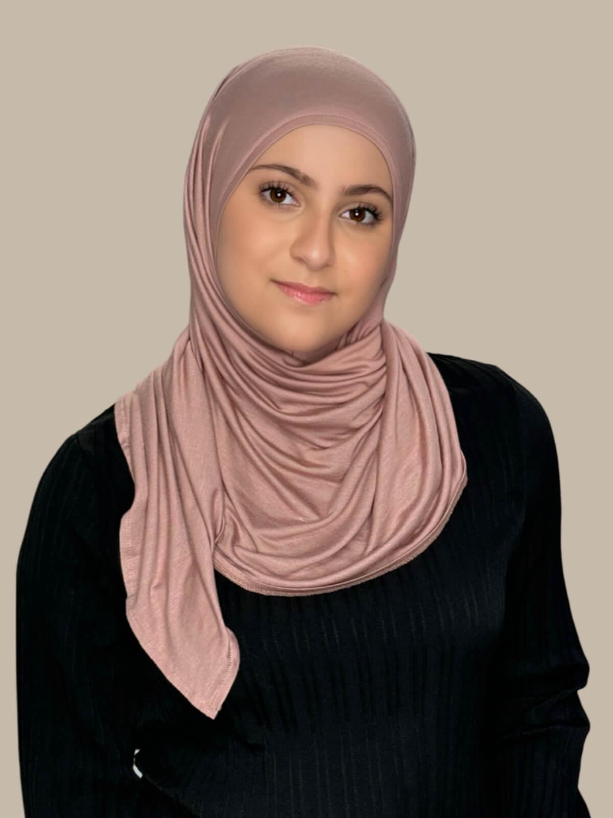 Dusty Rose Pre-Sewn Jersey Hijab in Modish Girl size, front view on model with hijab wrapped neatly around shoulders showing smooth fit and soft stretch fabric.