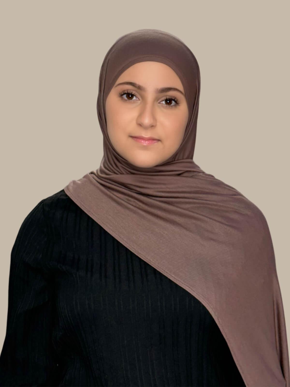 Mocha Brown Pre-Sewn Jersey Hijab in Modish Girl size, front view on model with hijab draped over shoulder showing smooth fit and soft stretch fabric. no pins
