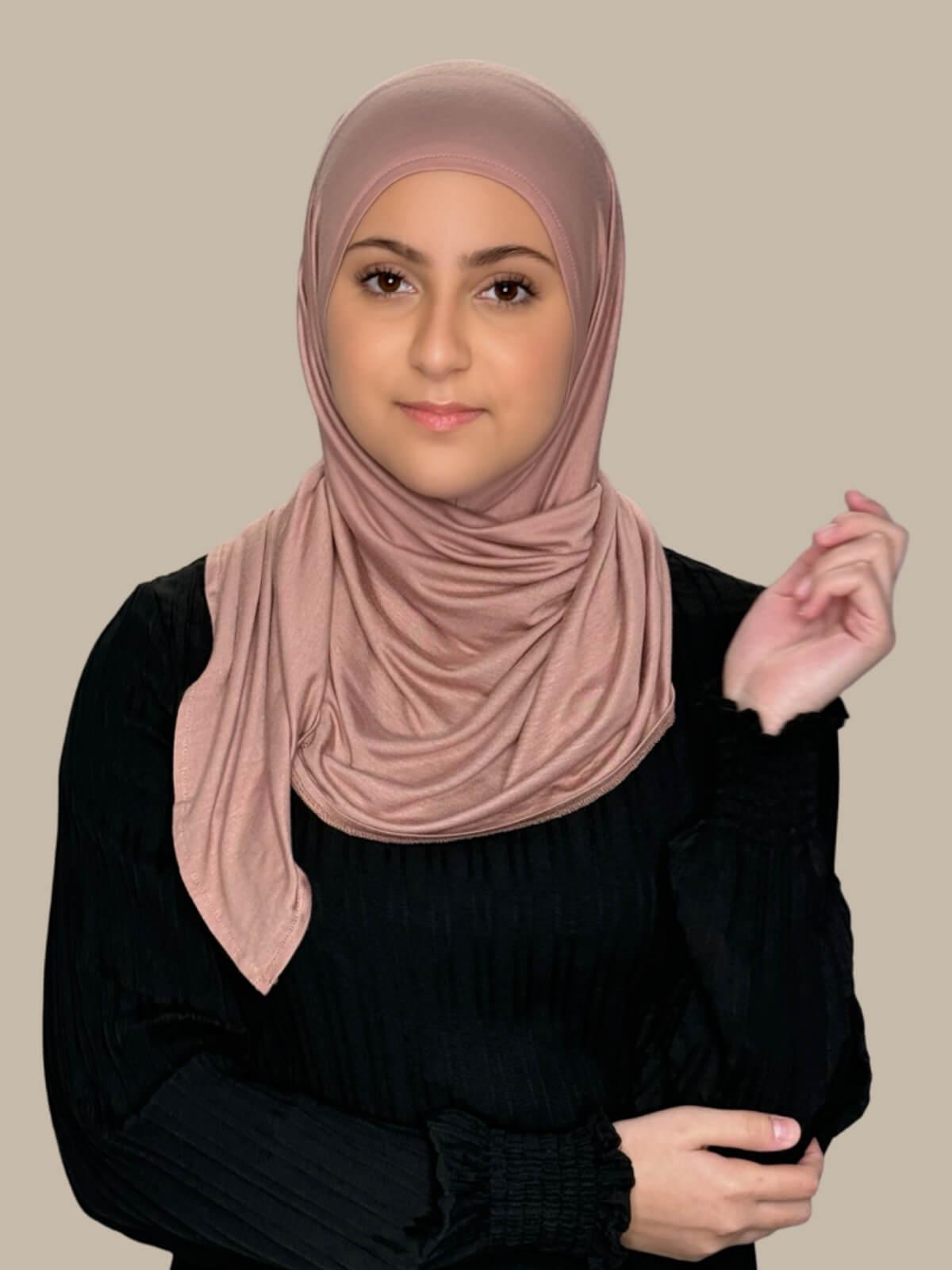 Dusty Rose Pre-Sewn Jersey Hijab in Modish Girl size, front view on model with hijab wrapped neatly around shoulders showing smooth fit and soft stretch fabric.