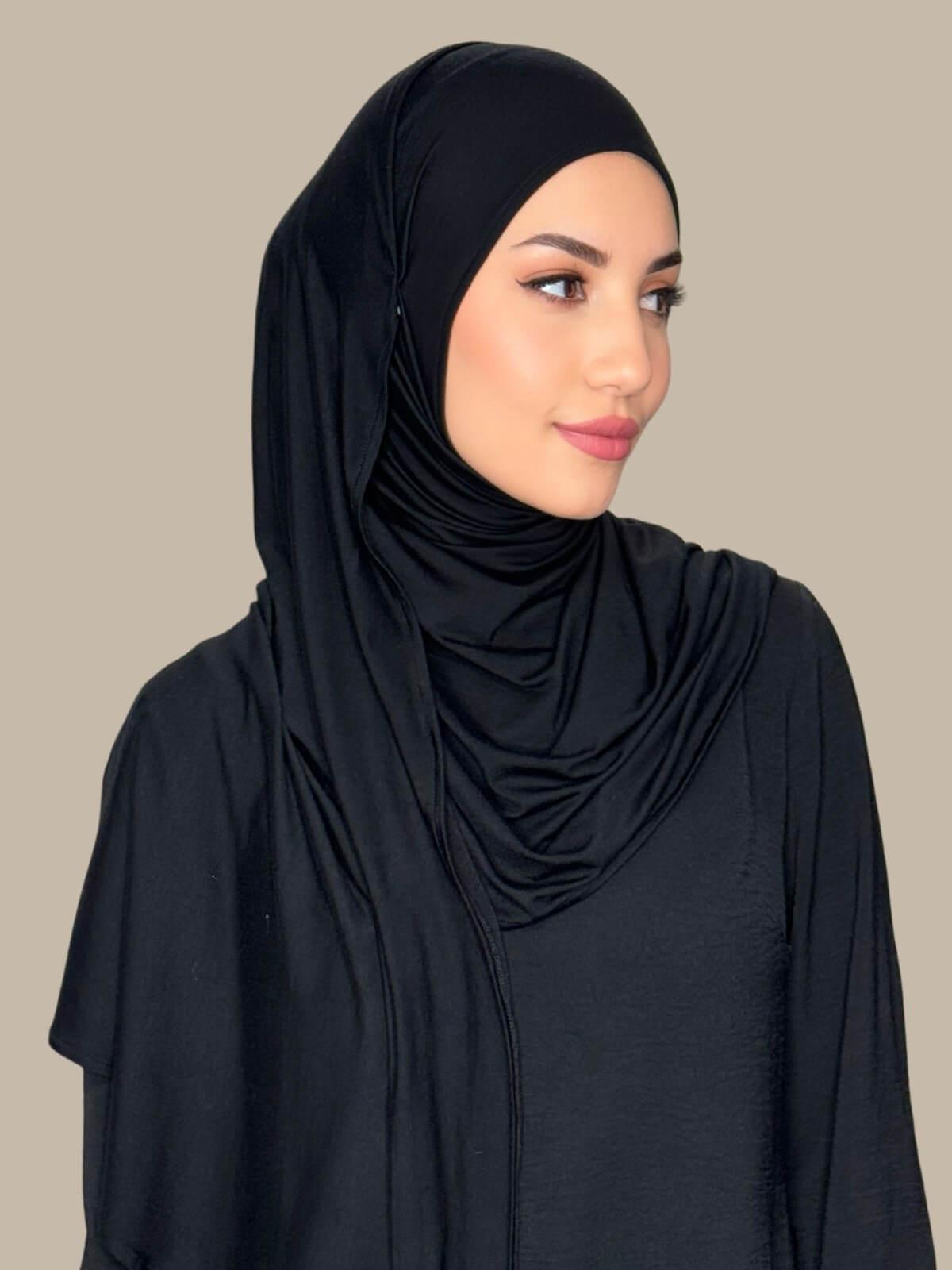 Side profile of model wearing Black Pre-Sewn Jersey Hijab highlighting natural stretch and clean finish around the face