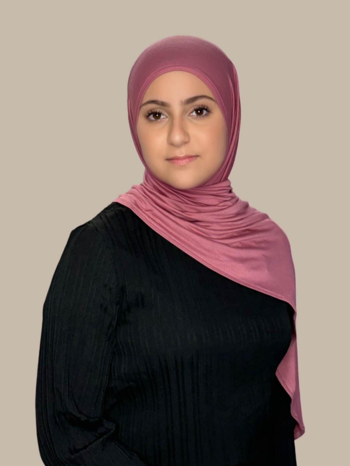 Pale Rose Pre-Sewn Jersey Hijab in Modish Girl size, side view on model with hijab draped over shoulder showing smooth fit and soft stretch
