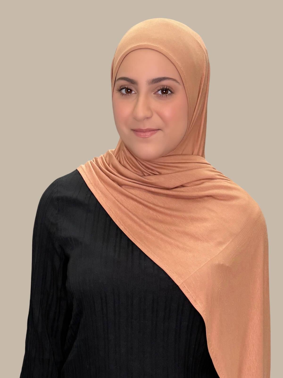 Sahara Pre-Sewn Jersey Hijab in Modish Girl size, front view on model with hijab draped over shoulder showing smooth fit and soft stretch fabric.
