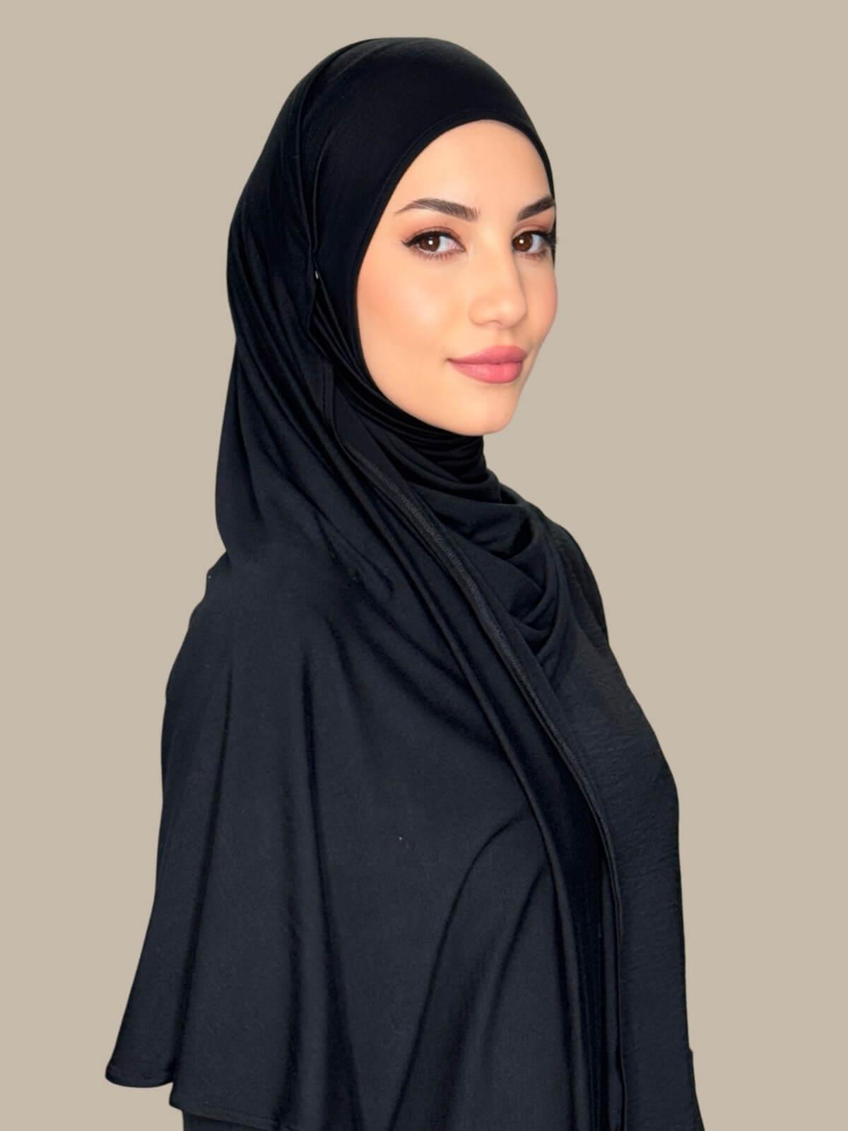 Side profile of model wearing Black Pre-Sewn Jersey Hijab highlighting natural stretch and clean finish around the face