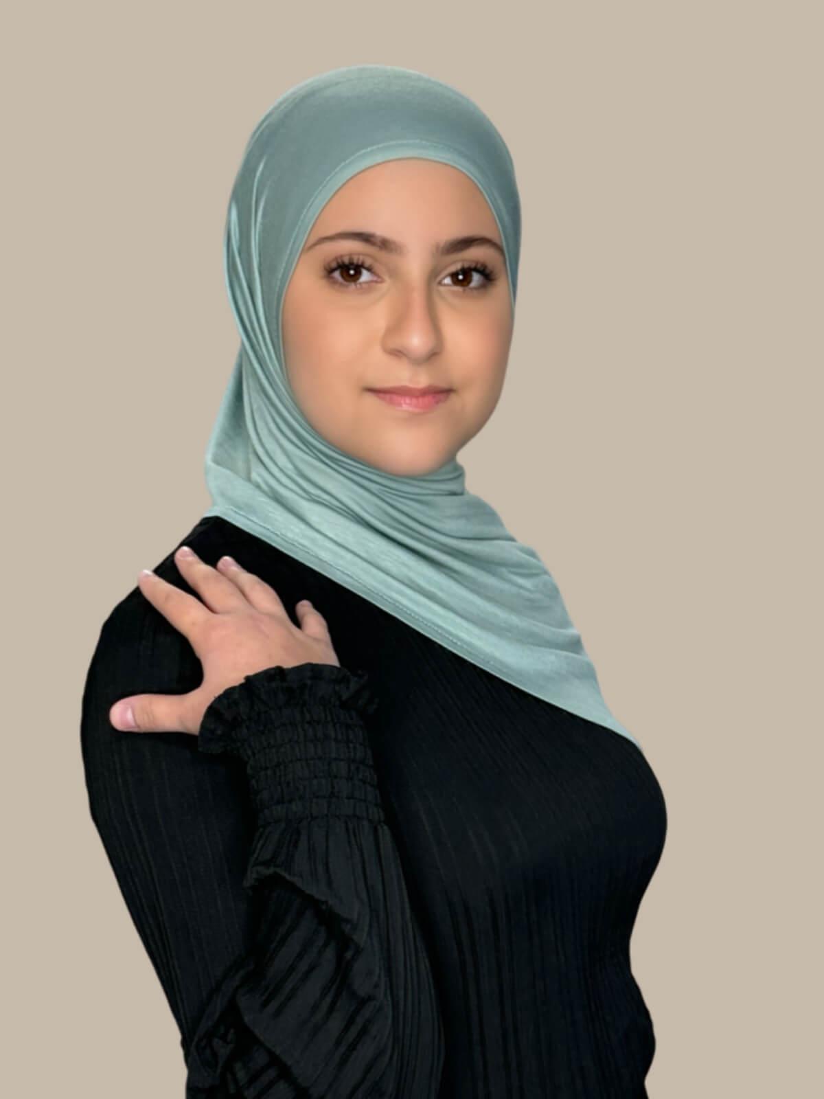 Pale Cyan Pre-Sewn Jersey Hijab in Modish Girl size, front view on model with hijab draped over shoulder showing smooth fit and soft stretch fabric.