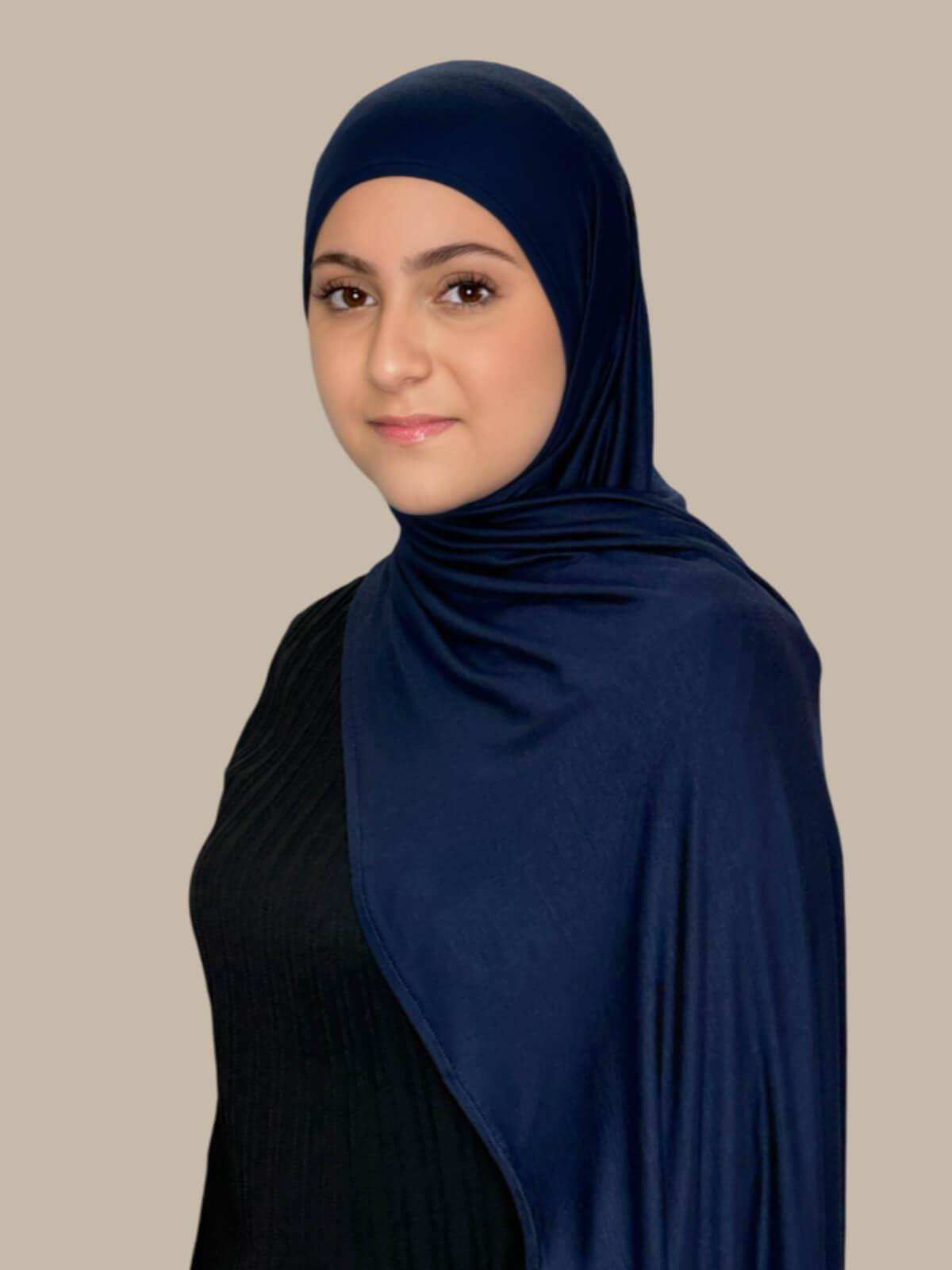 Navy Pre-Sewn Jersey Hijab in Modish Girl size, side view on model with hijab draped over shoulder showing smooth fit and soft stretch fabric.