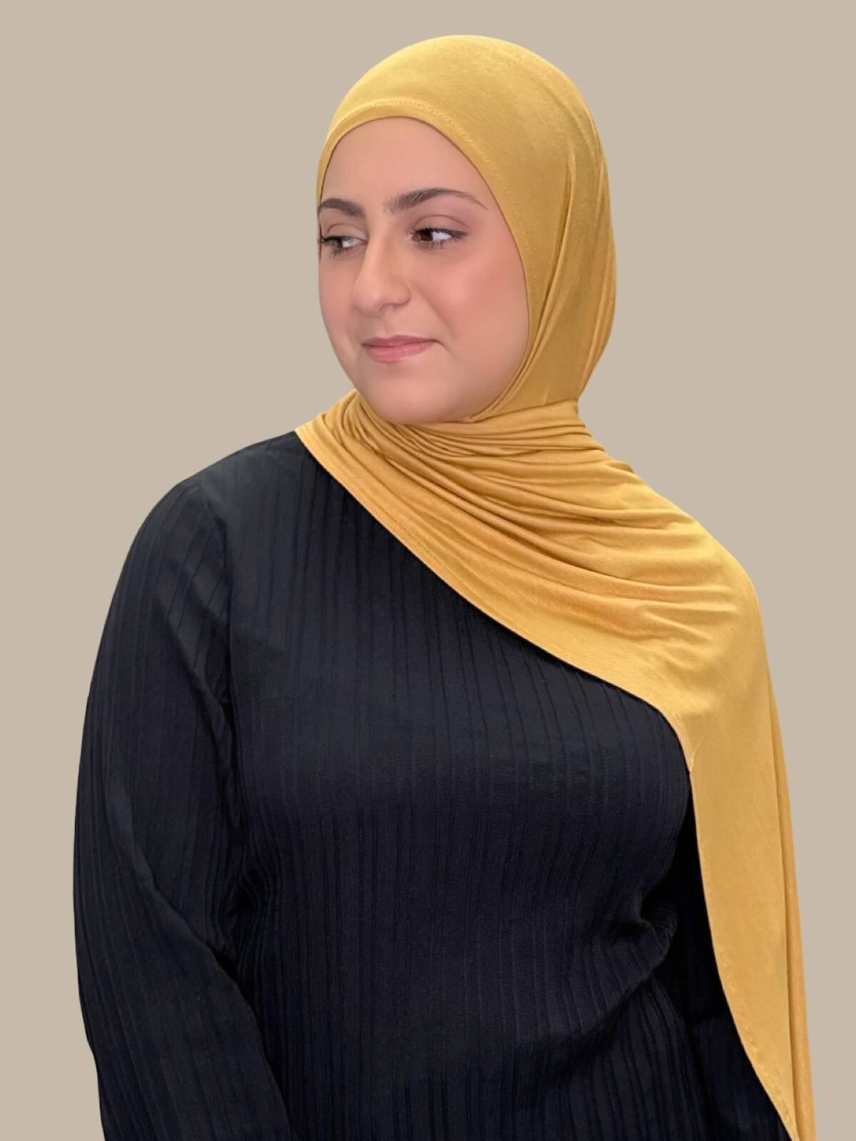 Saffron Pre-Sewn Jersey Hijab in Modish Girl size, front view on model with hijab draped over shoulder, no pins