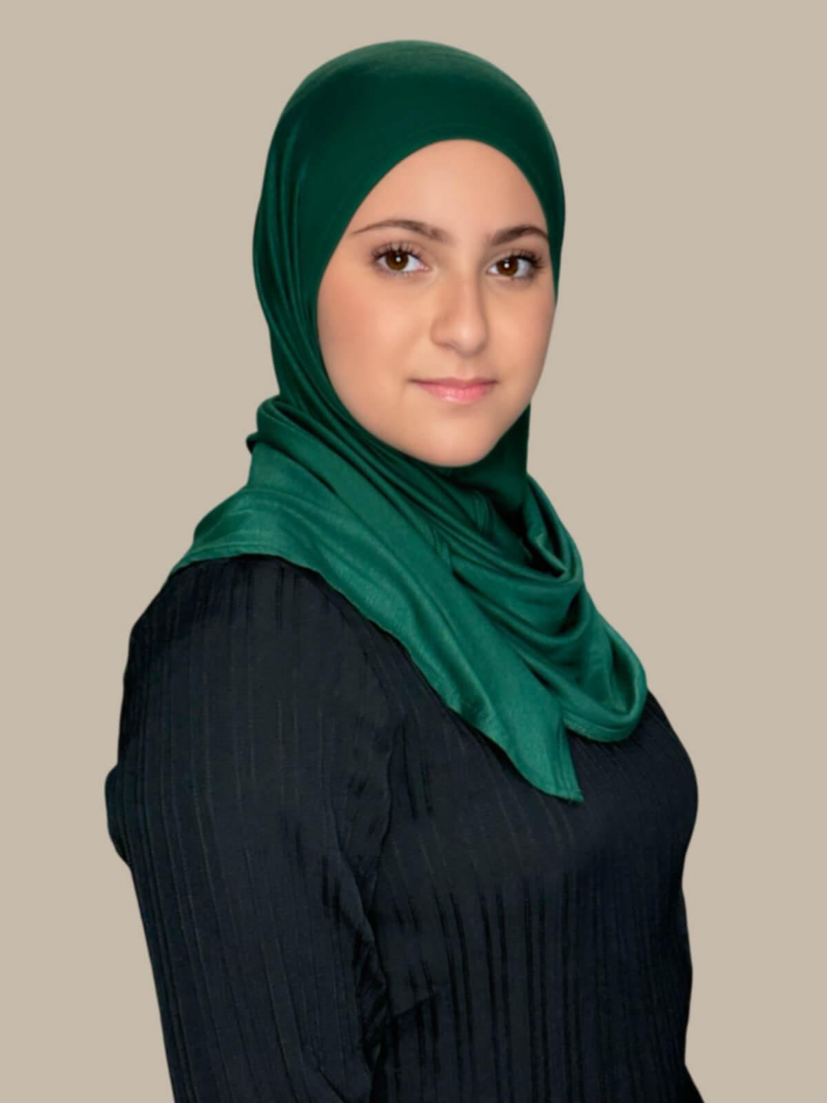 Forrest Green Pre-Sewn Jersey Hijab in Modish Girl size, side view on model with hijab wrapped neatly around shoulders showing smooth fit and soft stretch fabric.