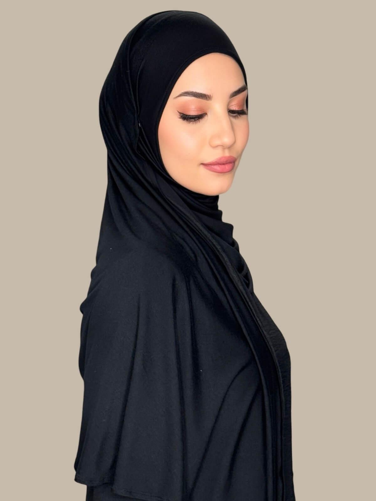 Side profile of model wearing Black Pre-Sewn Jersey Hijab highlighting natural stretch and clean finish around the face