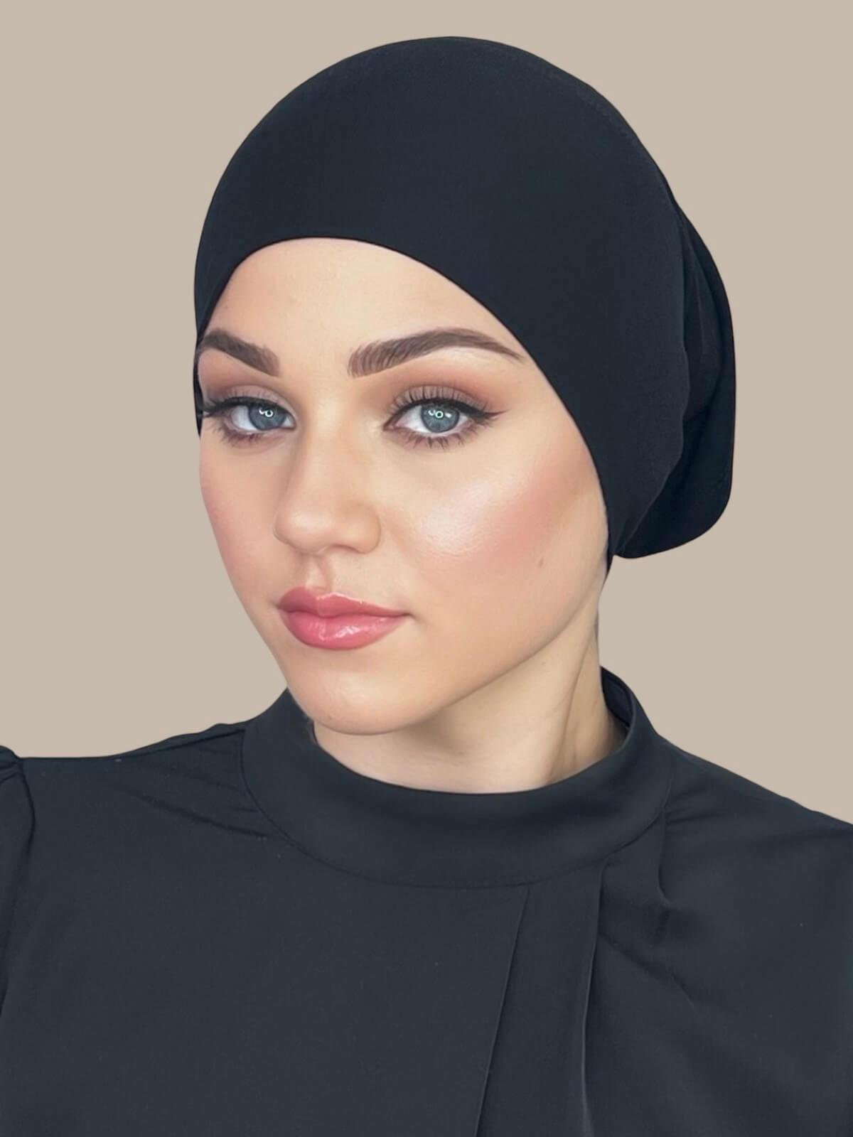 Black Premium Jersey Underscarf in tube style, front view on model showing smooth, snug fit and clean edge finish.