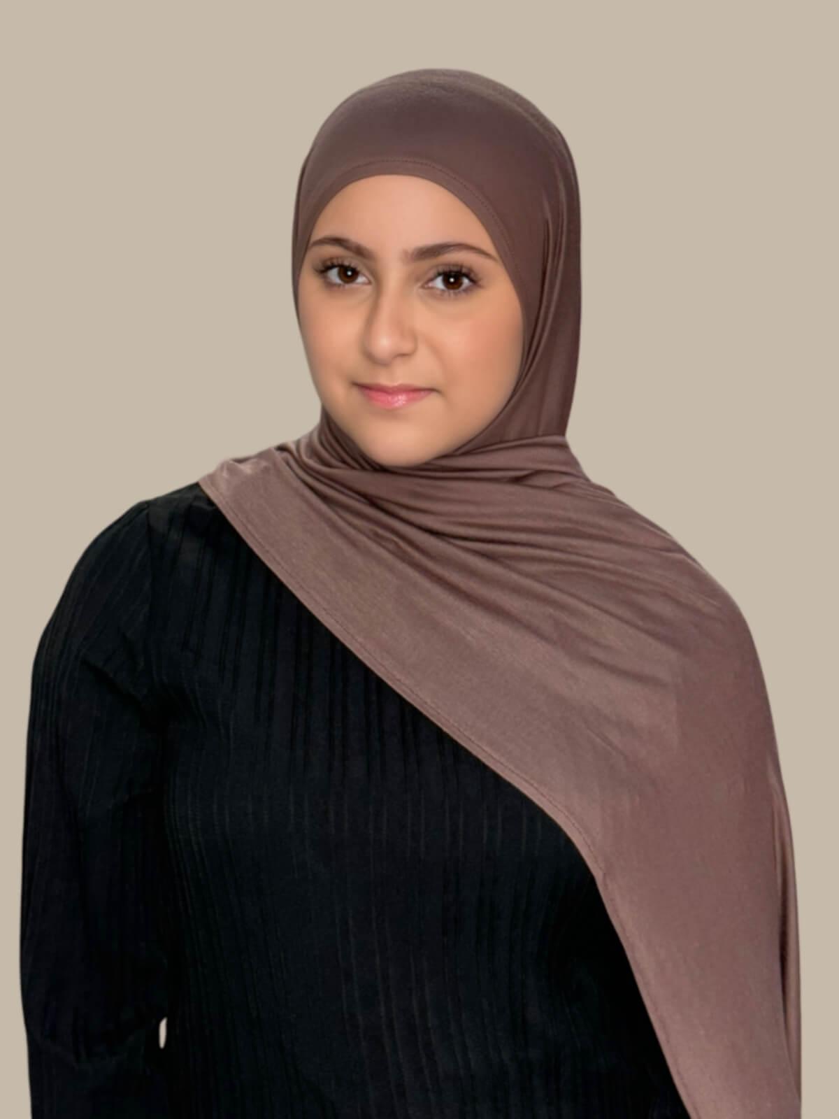 Mocha Brown Pre-Sewn Jersey Hijab in Modish Girl size, front view on model with hijab draped over shoulder showing smooth fit and soft stretch fabric.