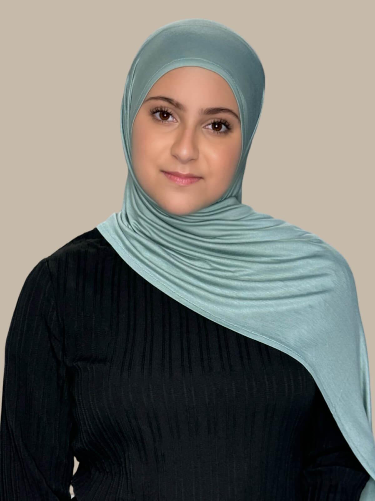 Pale Cyan Pre-Sewn Jersey Hijab in Modish Girl size, front view on model with hijab draped over shoulder