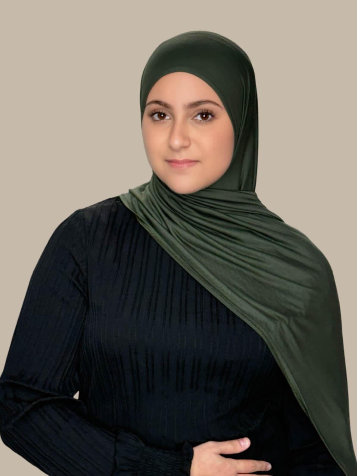 Army Green Pre-Sewn Jersey Hijab in Modish Girl size, front view on model with hijab draped over shoulder showing smooth fit and soft stretch 