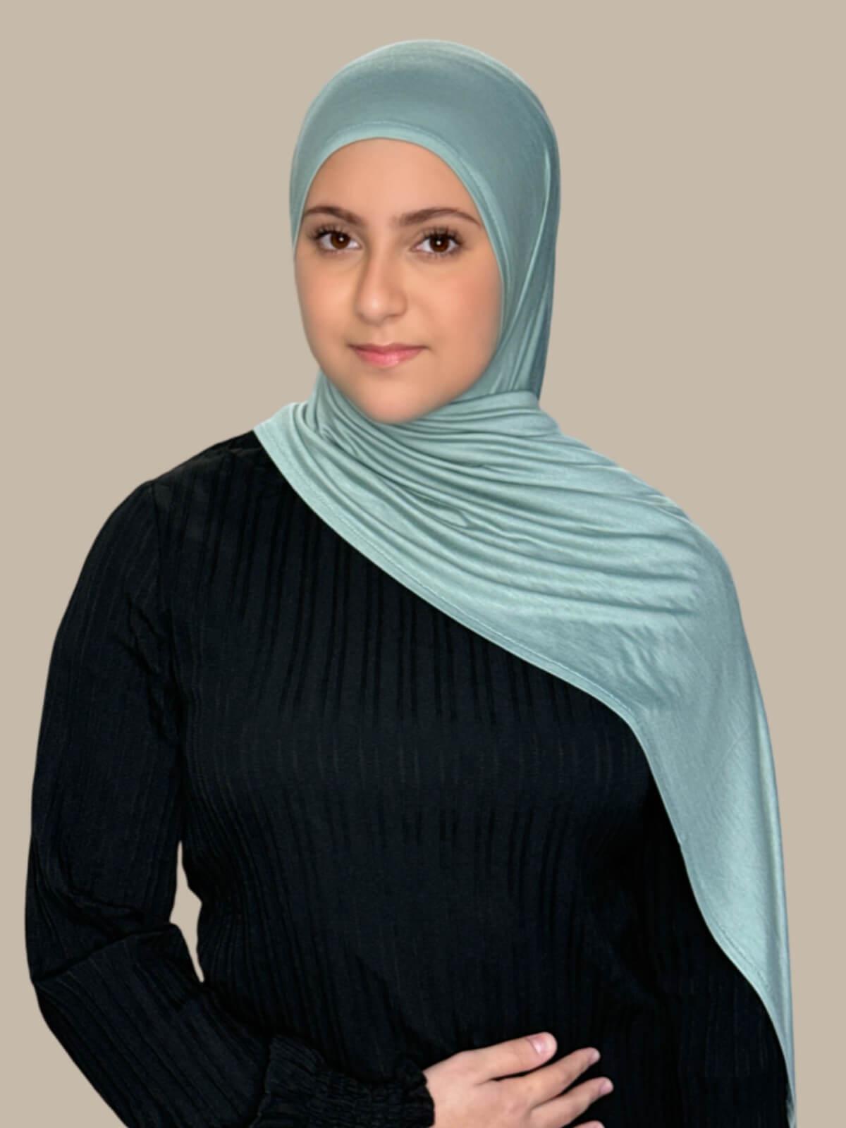 Pale Cyan Pre-Sewn Jersey Hijab in Modish Girl size, front view on model with hijab draped over shoulder no pins 
