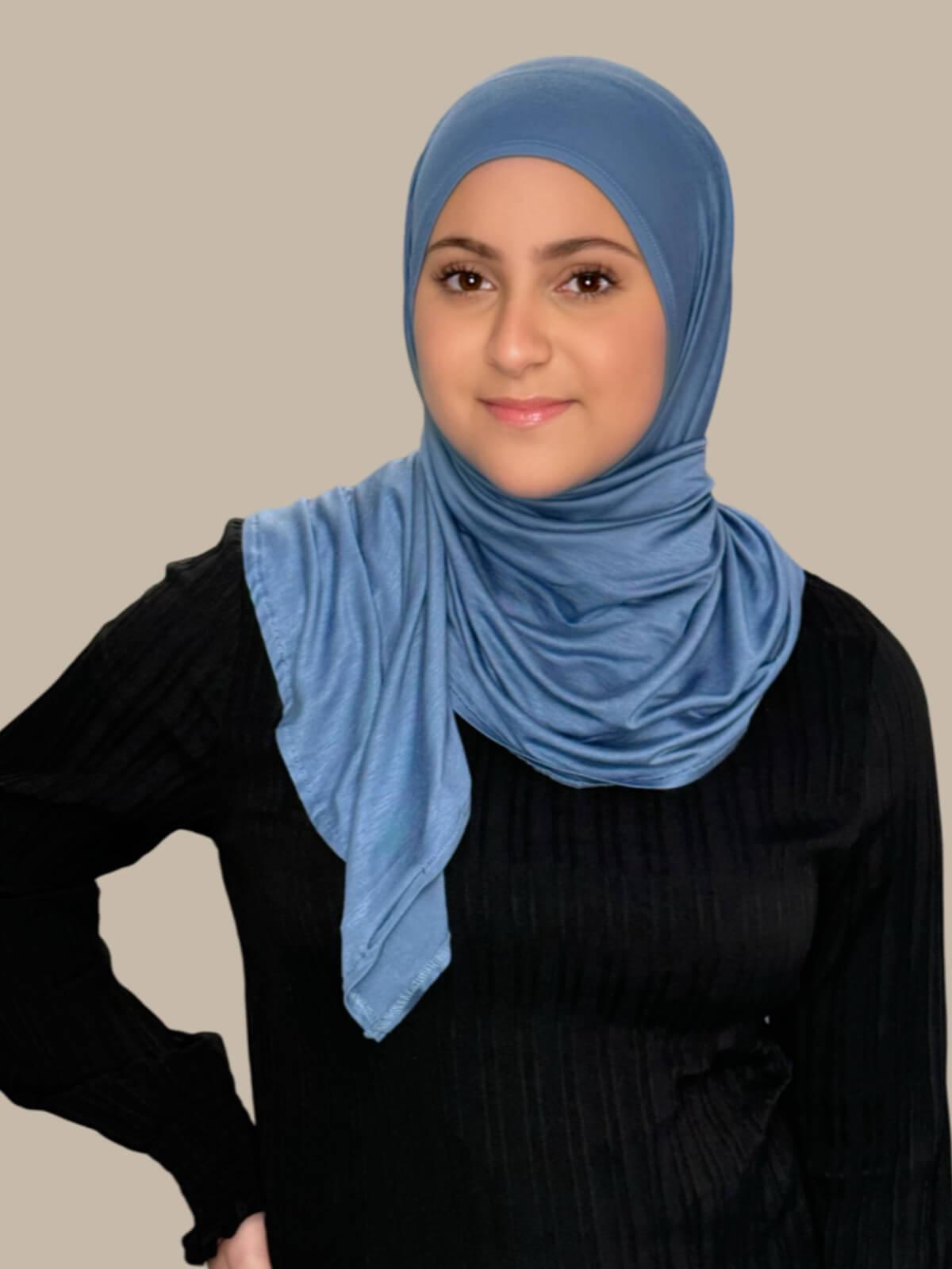 Blue Grey Pre-Sewn Jersey Hijab in Modish Girl size, front view on model with hijab wrapped neatly around shoulders showing smooth fit and soft stretch fabric.