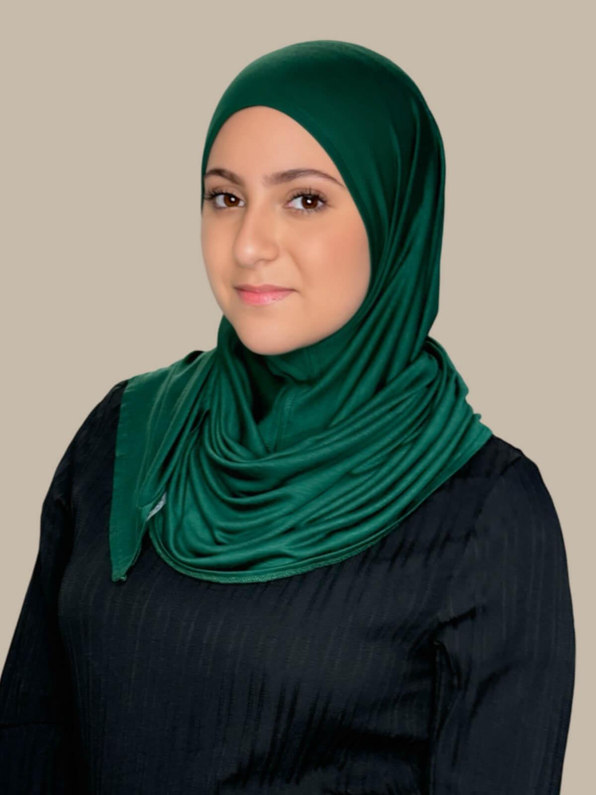 Forrest Green Pre-Sewn Jersey Hijab in Modish Girl size, front view on model with hijab wrapped neatly around shoulders showing smooth fit and soft stretch fabric. No pins effortless