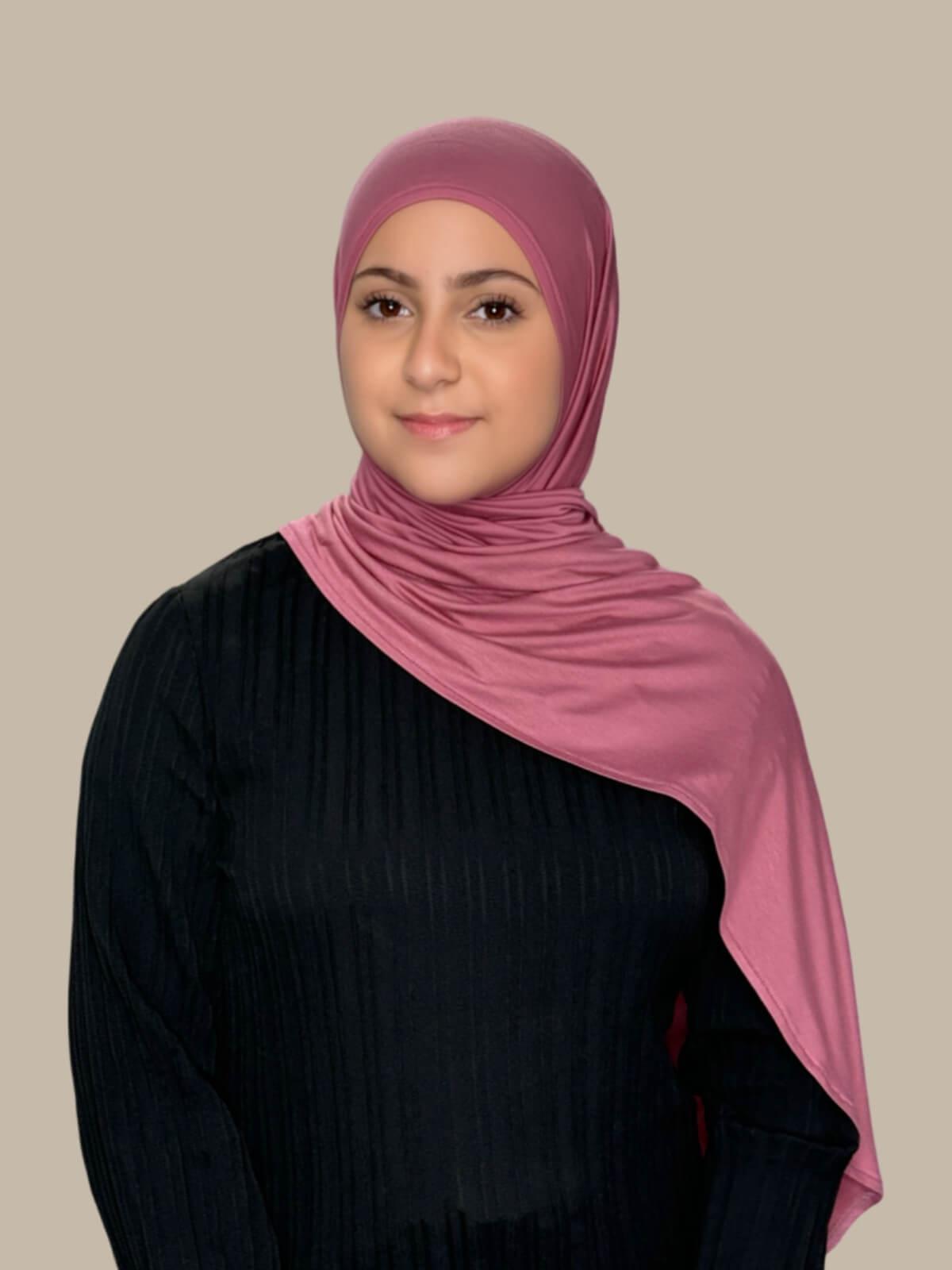 Pale Rose Pre-Sewn Jersey Hijab in Modish Girl size,front view on model with hijab draped over shoulder showing smooth fit and soft stretch 
