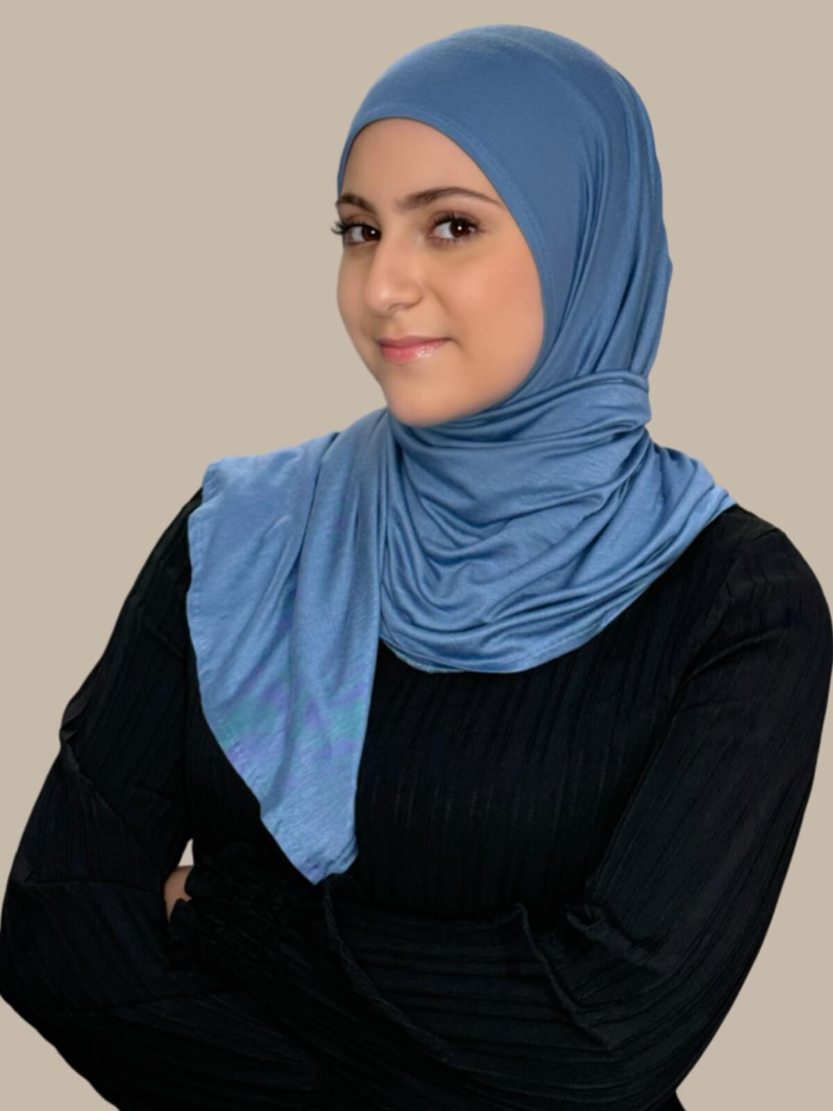 Blue Grey Pre-Sewn Jersey Hijab in Modish Girl size, front view on model with hijab wrapped neatly around shoulders showing smooth fit and soft stretch fabric.