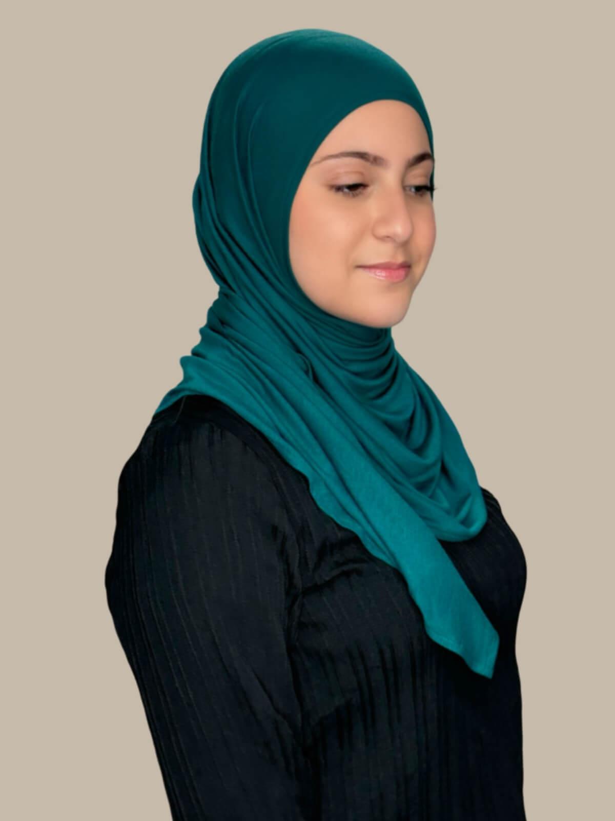 Pined Green Pre-Sewn Jersey Hijab in Modish Girl size, side view on model with hijab wrapped neatly around shoulders showing smooth fit and soft stretch fabric.